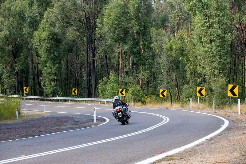 Motorcyclist approach bend on country road